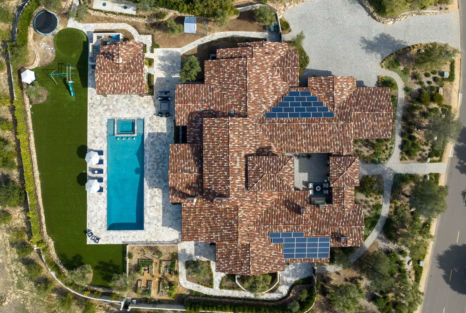 Aerial view of Tuscan estate with pool and solar panels